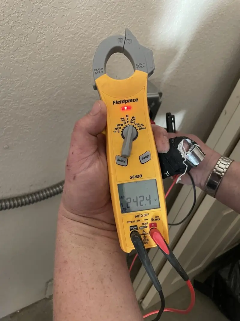 Voltage testing with clamp meter during Outlet Installation in Pana